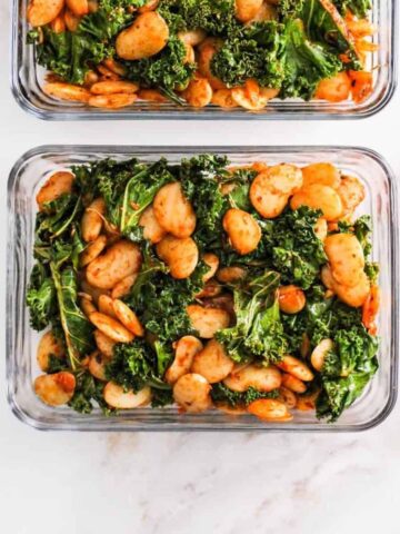 Square image of butter beans and greens in a meal prep container.