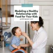 Square image of a mother feeding her child with text reading, "Modeling a Healthy Relationship with Food for Your Kids."