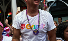 A bystander wears a Grindr t-shirt during the NYC Pride March