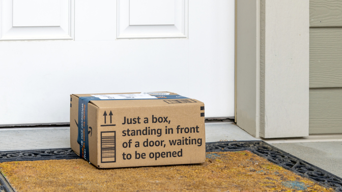 Amazon package sitting on doormat in front of door