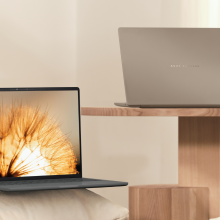 the asus zenbook a14 on a wood table and a white pillow