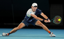 Alex de Minaur of Australia plays a backhand