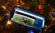 NORAD Tracks Santa app on a smartphone in a christmas tree 