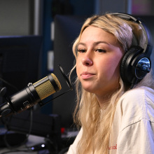 haliey welch sitting in front of a micrphone