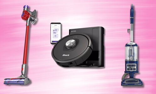 Three vacuum cleaners on a pink background: a red Dyson cordless stick vacuum, a black Shark robot vacuum with self-empty base, and a blue Shark Navigator Lift-Away upright vacuum.