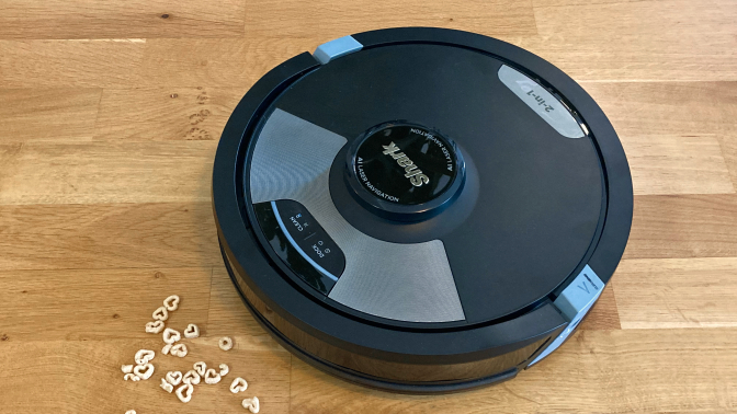 shark ai ultra 2 in 1 robot vacuum on hardwood floor approaching cheerios