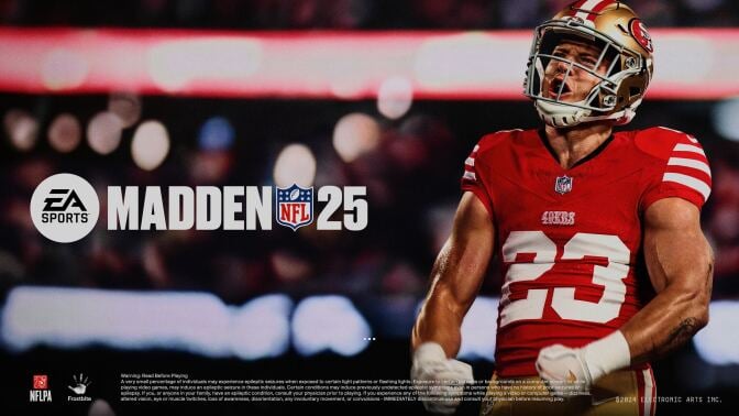 The image is a promotional cover for the video game "Madden NFL 25" by EA Sports. It features a football player in a red San Francisco 49ers uniform (number 23) with his arms flexed and an intense expression on his face. The background is blurred, highlighting the player in the foreground. The logos for EA Sports, NFLPA, and Frostbite are visible at the bottom, along with a warning about epileptic seizures and the copyright notice for Electronic Arts Inc. for 2024