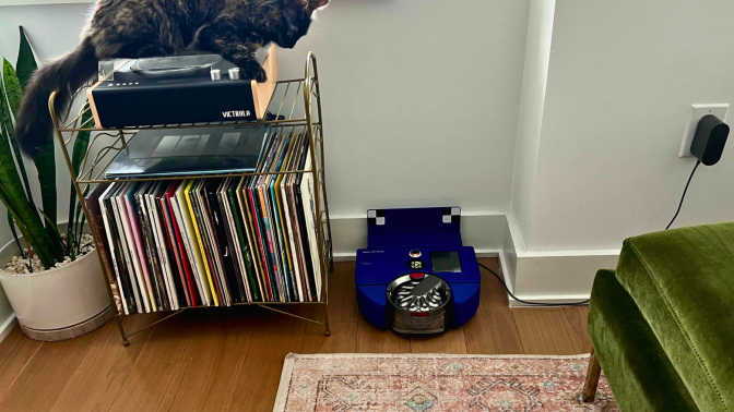 Dyson 360 Vis Nav robot vacuum sitting against wall in between 