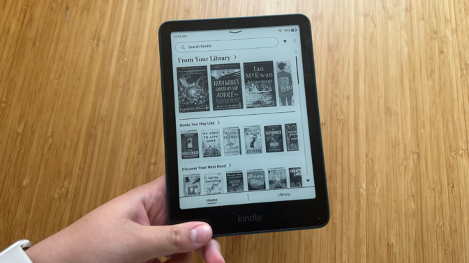 A person holding the Kindle Paperwhite Signature Edition