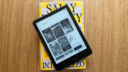 A Kindle Paperwhite on top of a copy of Intermezzo by Sally Rooney