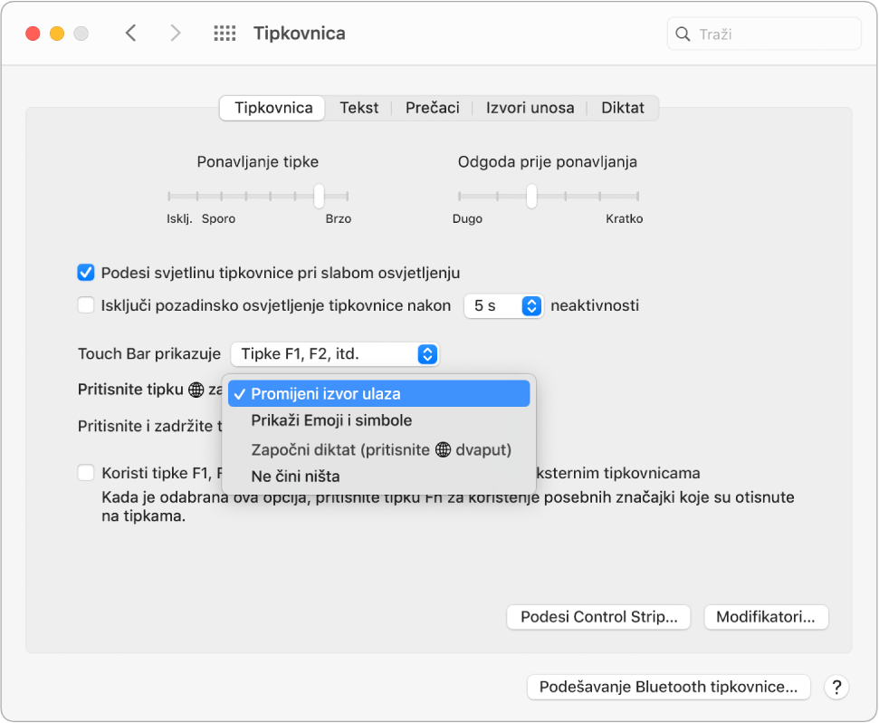 Prozor Postavke tipkovnice s padajućim izbornikom prikazuje opcije za Funkcijsku tipku/tipku Globus: Promjena izvora unosa, Prikaz emojija i simbola, Pokreni Diktat ili Nemoj učiniti ništa.