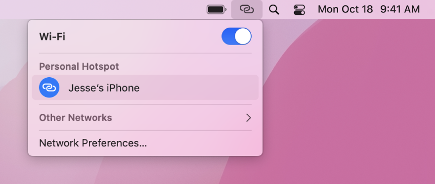 A Mac screen with the Wi-Fi menu showing a Personal Hotspot connected to an iPhone.