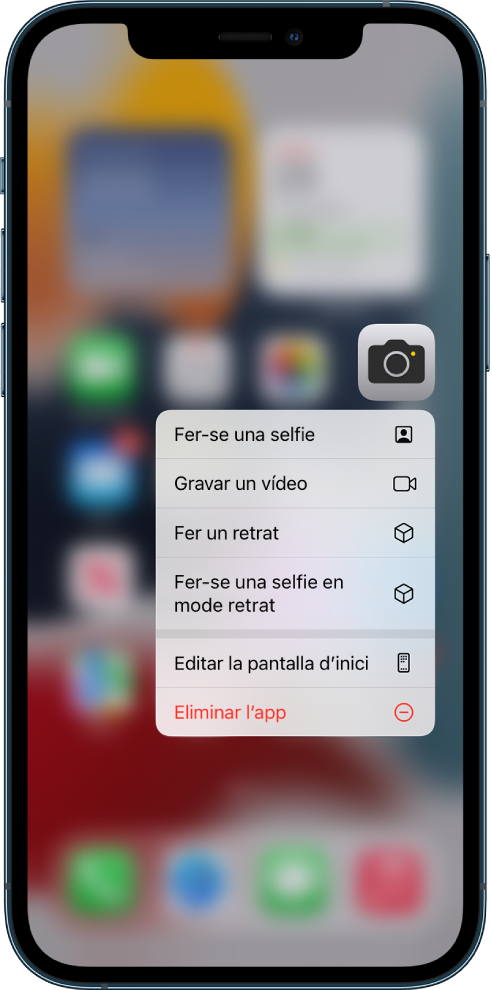 La pantalla d’inici difuminada, amb el menú d’accions ràpides de la Càmera a sota de l’app Càmera.