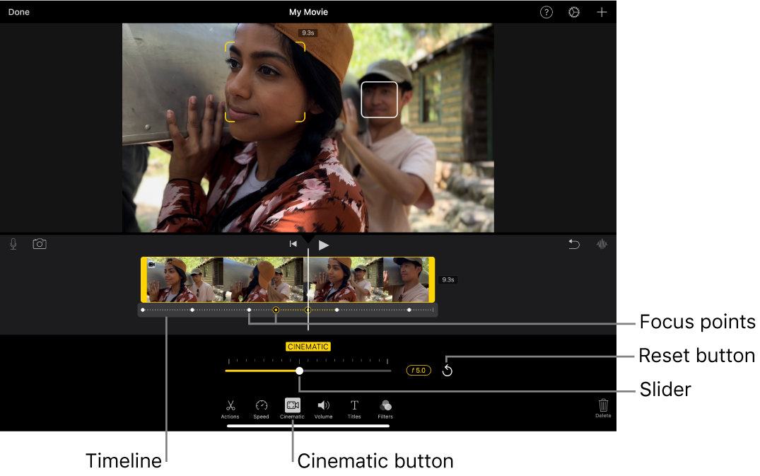 A Cinematic mode video clip in the viewer, with yellow brackets around the object currently in focus and a white box around an object not in focus. The timeline shows white and yellow focus points.