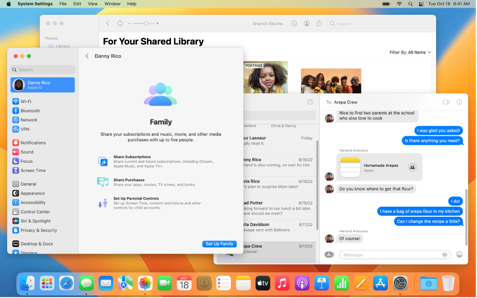 Bureau d’un Mac avec plusieurs fenêtres ouvertes : « Réglages Système » affiche les réglages « Partage familial », Photos présente une photothèque partagée iCloud et la fenêtre Messages montre une conversation qui inclut une note sur laquelle un groupe collabore.