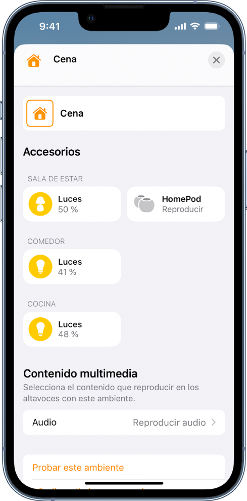 La pantalla de edición de ambientes en la app Casa. El nombre del ambiente está en la parte superior de la pantalla. Debajo hay tres habitaciones y los accesorios que se han añadido a cada habitación como parte del ambiente. Cerca de la parte inferior de la pantalla está la sección Multimedia, donde se ha configurado un HomePod de la sala de estar para reproducir audio. El botón “Probar este ambiente” está en la parte inferior de la pantalla.