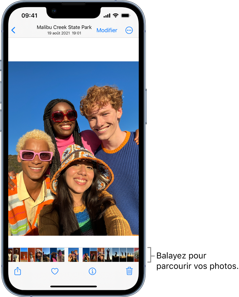 Une photo, avec les vignettes d’autres photos au bas de l’écran. En haut à gauche, le bouton Retour permet de revenir à l’affichage que vous étiez en train de parcourir. En bas, vous trouverez les boutons Partager, Aimer et Supprimer. En haut à droite se trouve le bouton Modifier.