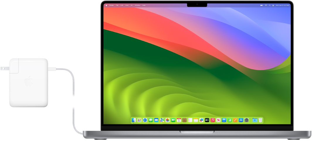 Un MacBook Pro 16 pouces avec l’adaptateur secteur branché.