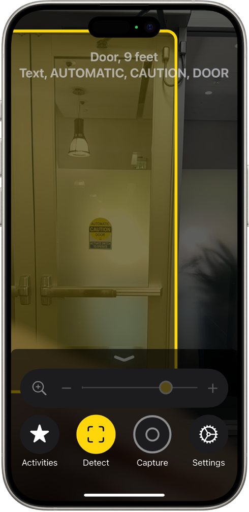 The Magnifier app is open and a door is being detected. A description shows how far away the door is and what the text on the door says.