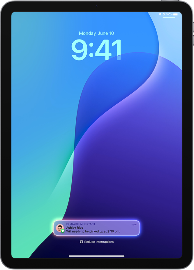 An iPad showing a time-sensitive notification on the Lock Screen with the Reduce Interruptions Focus turned on.
