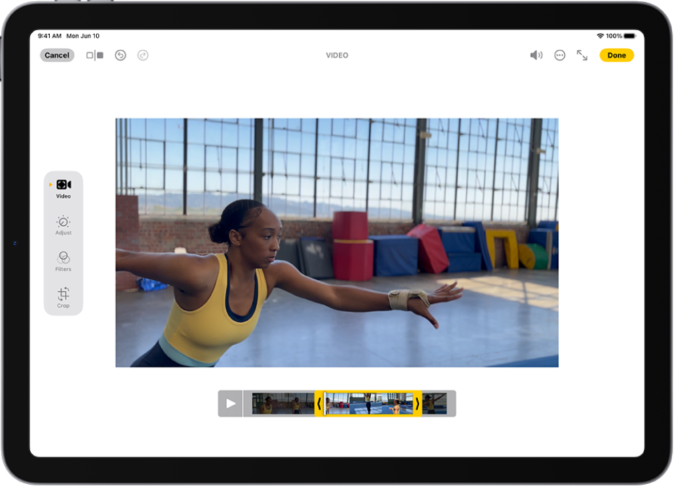 The Edit screen in the Photos app with a video playing in the center. The video’s frame viewer is across the bottom of the video and a yellow outline is around the selected frames to include in the trimmed video. On the left side of the screen are the Video, Adjust, Filters, and Crop buttons; the Video button is selected.