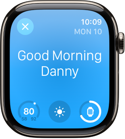 L’Apple Watch qui affiche l’écran de réveil. Le mot « Bon matin » s’affiche dans le haut. La température, la météo et le niveau de batterie s’affichent en dessous.