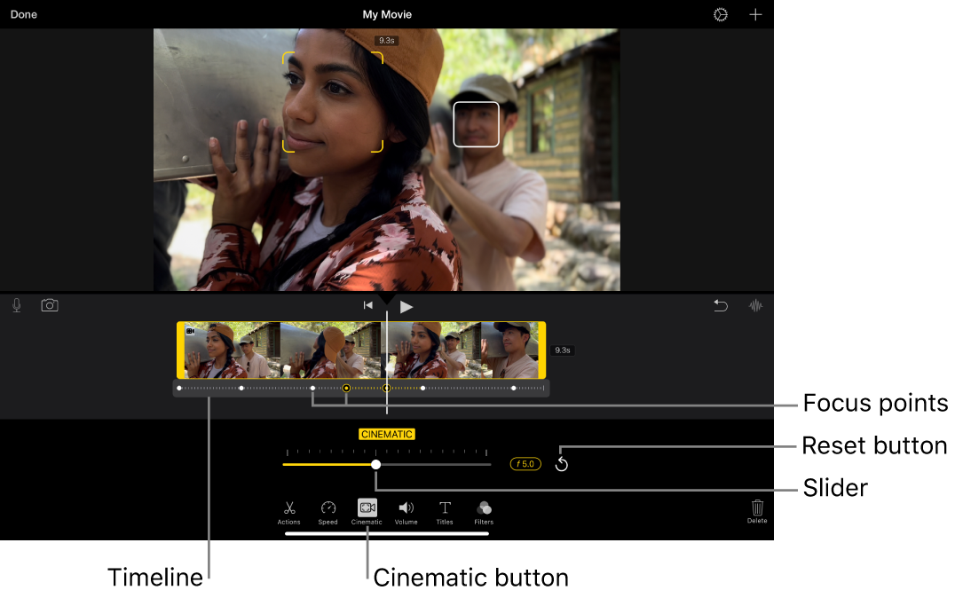 A Cinematic mode video clip in the viewer, with yellow brackets around the object currently in focus and a white box around an object not in focus. The timeline shows white and yellow focus points.