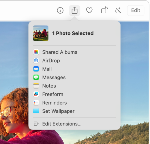 The Share menu, shown from the Share button in the Photos toolbar. The Share menu includes, from top to bottom, Shared Albums, AirDrop, Mail, Messages, Notes, Reminders and Set Wallpaper. The last item is Edit Extensions.