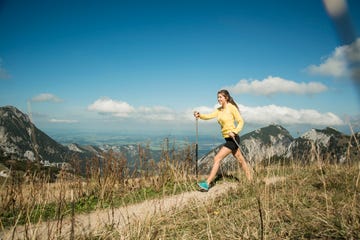 austria, tyrol, tannheim valley, young woman nordic walking in mountains