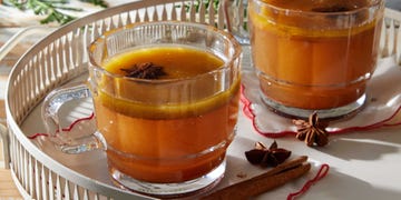 a mug of alchohol free hot buttered rum on a white tray