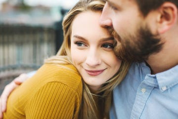 Close up of romantic young couple on city rooftop terrace