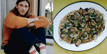 a person with a cozy sweater and socks alongside a plate of linguine with clams