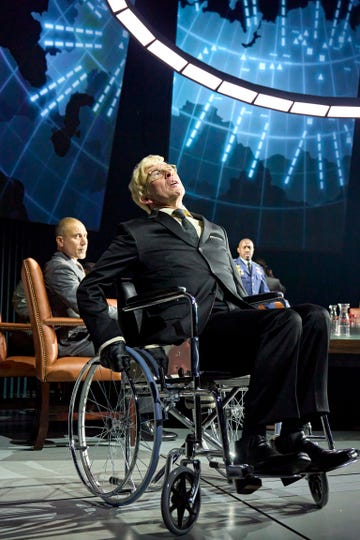 A man in a wheelchair during a discussion panel