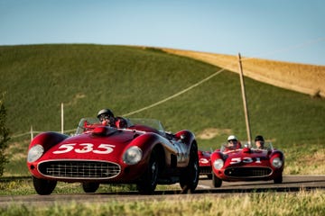 a pair of red race cars on a track