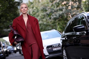 milan, italy september 21 leonie hanne wears red long dress, red coat, burgundy ferragamo big bag, outside ferragamo, during the milan fashion week menswear springsummer 2025 on september 21, 2024 in milan, italy photo by claudio laveniagetty images