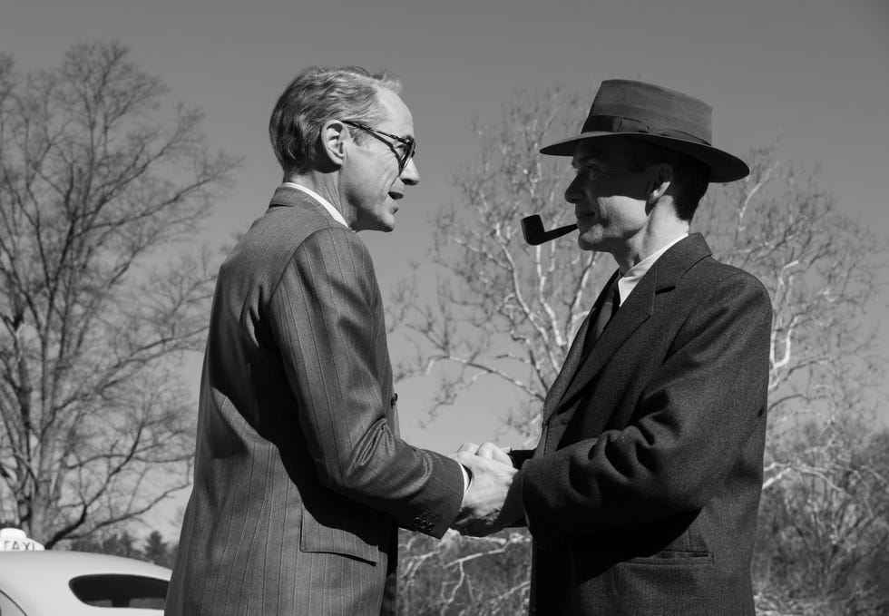 l to r robert downey jr is lewis strauss and cillian murphy is j robert oppenheimer in oppenheimer, written, produced, and directed by christopher nolan