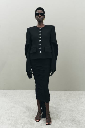 Fashion model wearing a sophisticated black outfit with distinct features