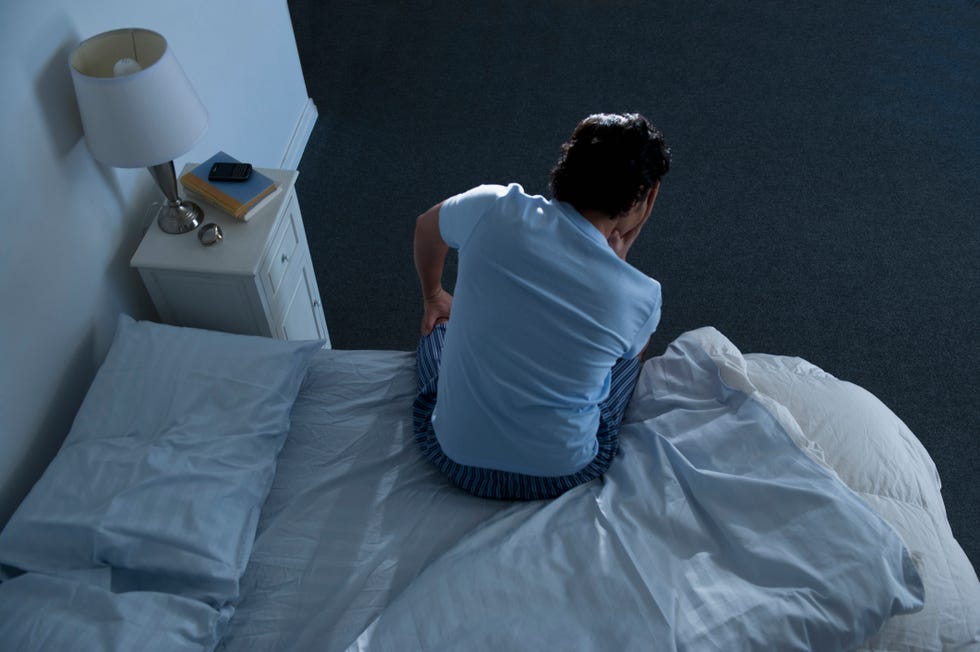 usa, new jersey, jersey city, man sitting on bed