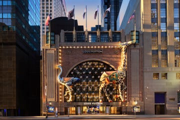 exterior view of a louis vuitton store featuring large animal sculptures