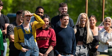 group of people standing outdoors some shielding their eyes from the sun