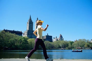 woman speed walking along lake