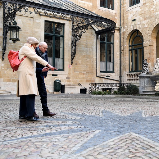 Couple on tour pointing at star