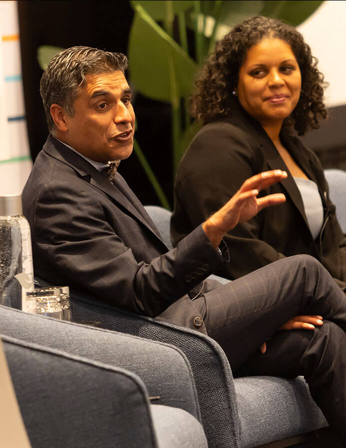 adimika arthur and colleague talking at a conference