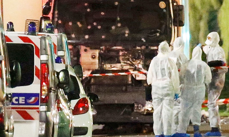 French police forces and forensic officers stand next to a truck July 15, 2016 that ran into a crowd celebrating the Bastille Day national holiday.—Reuters