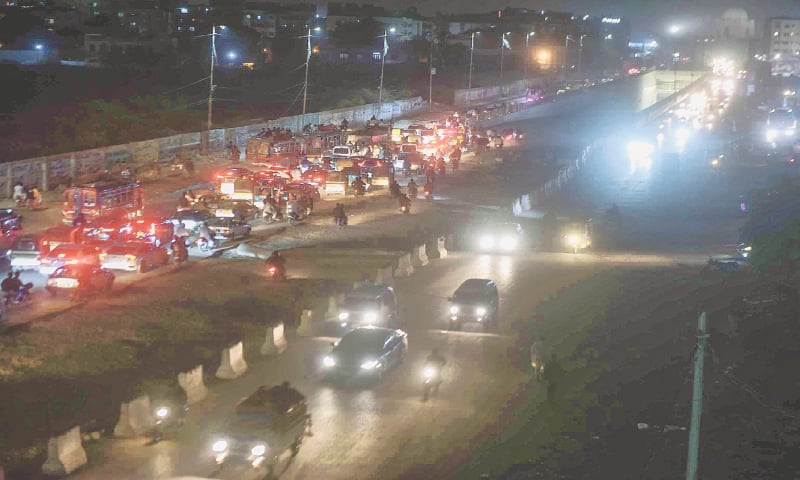 Vehicular traffic on M.A. Jinnah Road passes by the incomplete BRT Green Line corridor ascending from the underground bus station at Numaish, on Tuesday. —Fahim Siddiqi / White Star