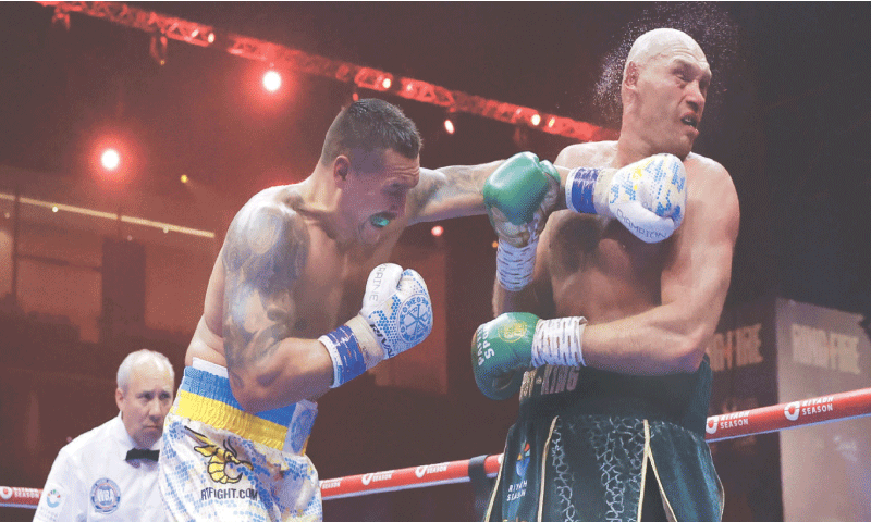 OLEKSANDR Usyk (L) of Ukraine punches Britain’s Tyson Fury during their heavyweight boxing world championship bout at the Kingdom Arena.—Reuters