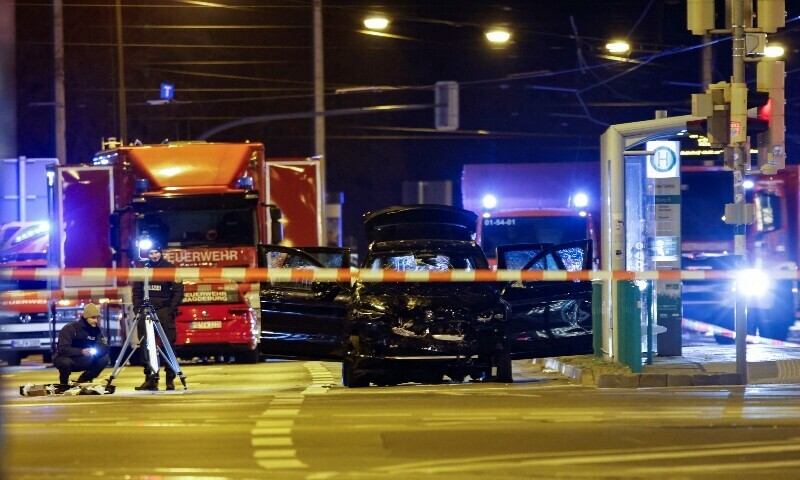 Emergency personnel stand next to a damaged car that drove into a group of people, according to local media, in Magdeburg, Germany, December 21, 2024. — Reuters