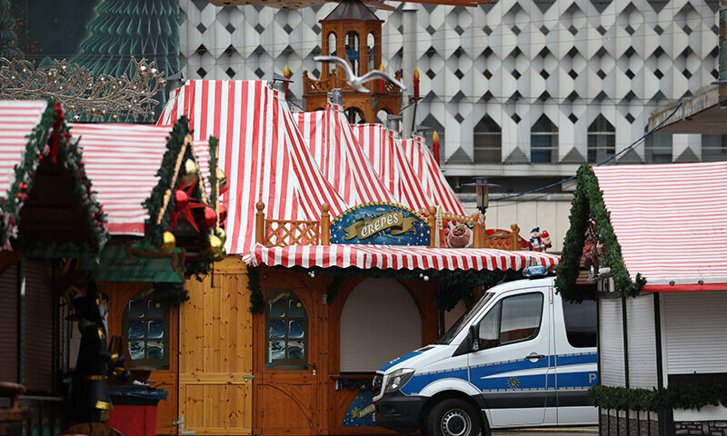 A police vehicle is seen among closed stalls at the site of a car-ramming attack on a Christmas market in Magdeburg on December 21. — AFP