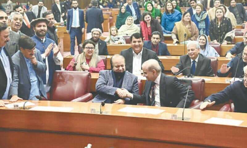 ISLAMABAD: PML-N supremo Nawaz Sharif congratulates his younger brother Shehbaz as party members thump desks in the National Assembly following the latter’s victory in the PM’s election, on Sunday.—White Star