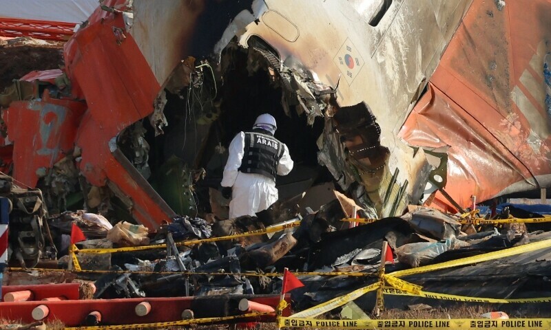 An official from the Ministry of Land, Infrastructure and Transport’s Aviation and Railway Accident Investigation Committee takes part in the investigation at the site where a Jeju Air Boeing 737-800 aircraft crashed and burst into flames at Muan International Airport in Muan, some 288 kilometres southwest of Seoul on January 2, 2025. — AFP